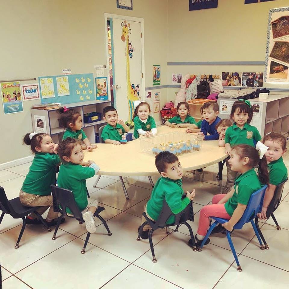 Children sitting around a table in a classroom