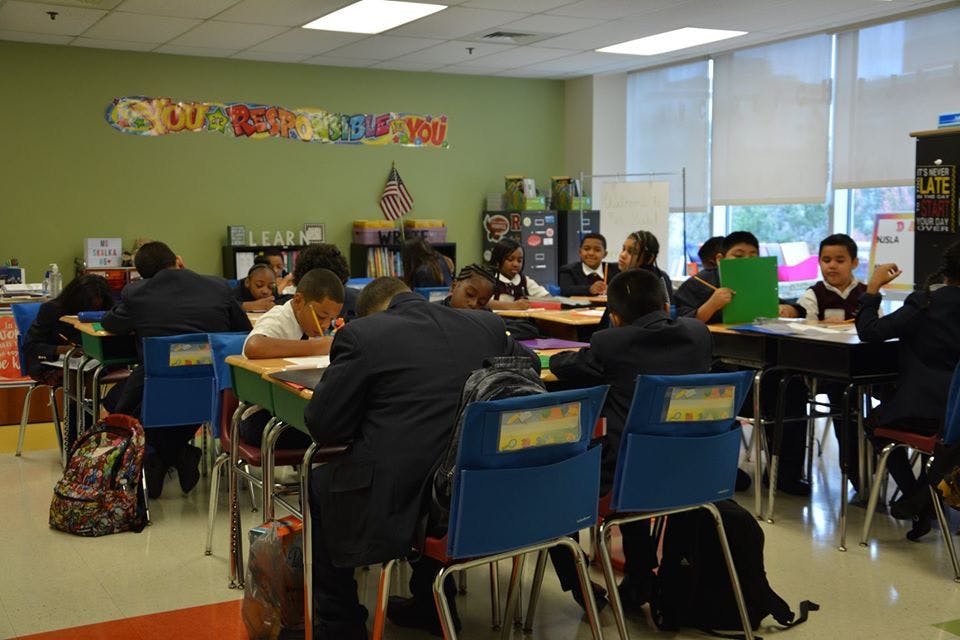 Children sitting at desks in a classroom