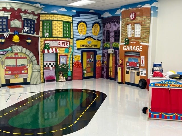Playroom with building facades and a road on the floor