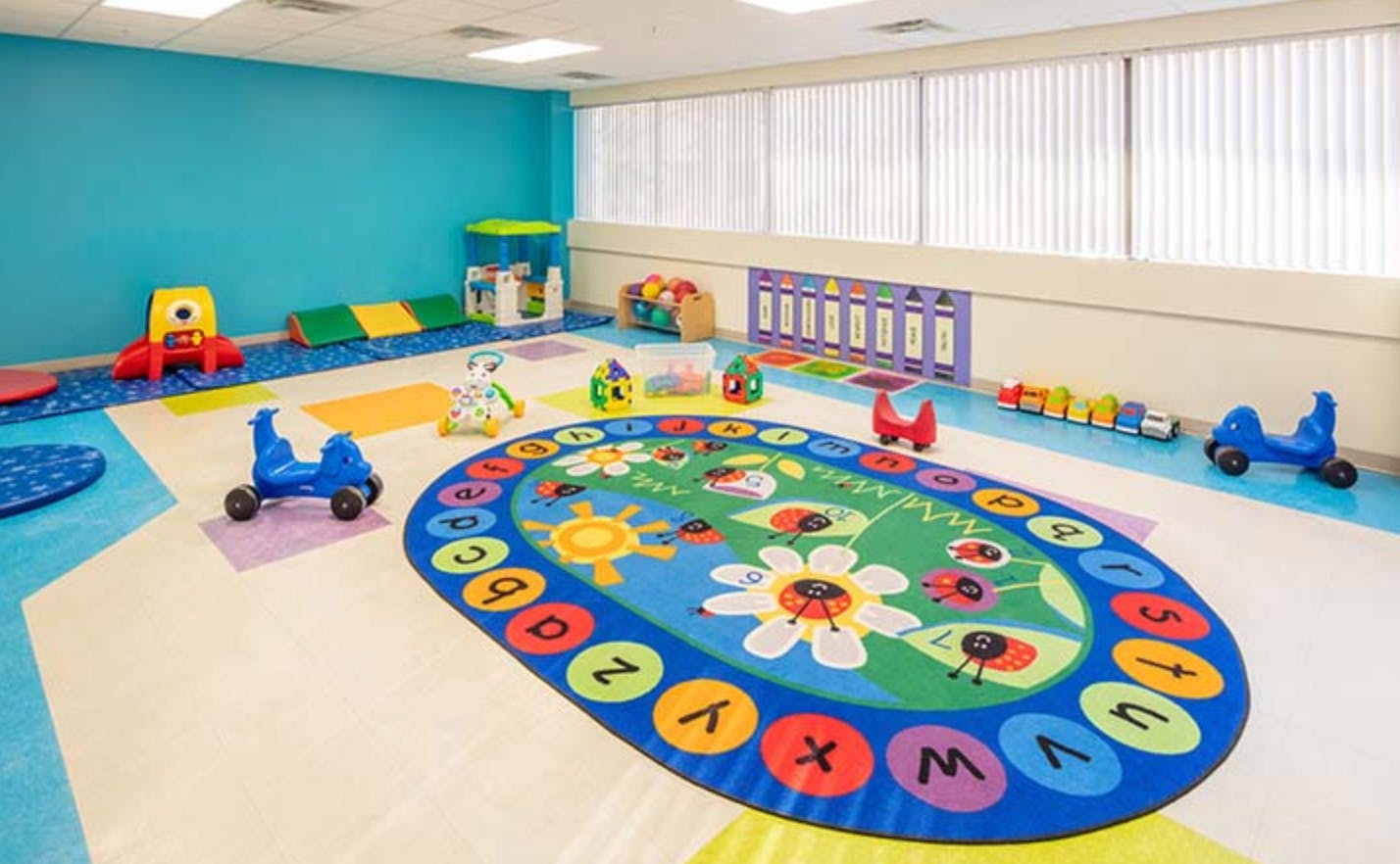 Playroom with colorful rug and various toys