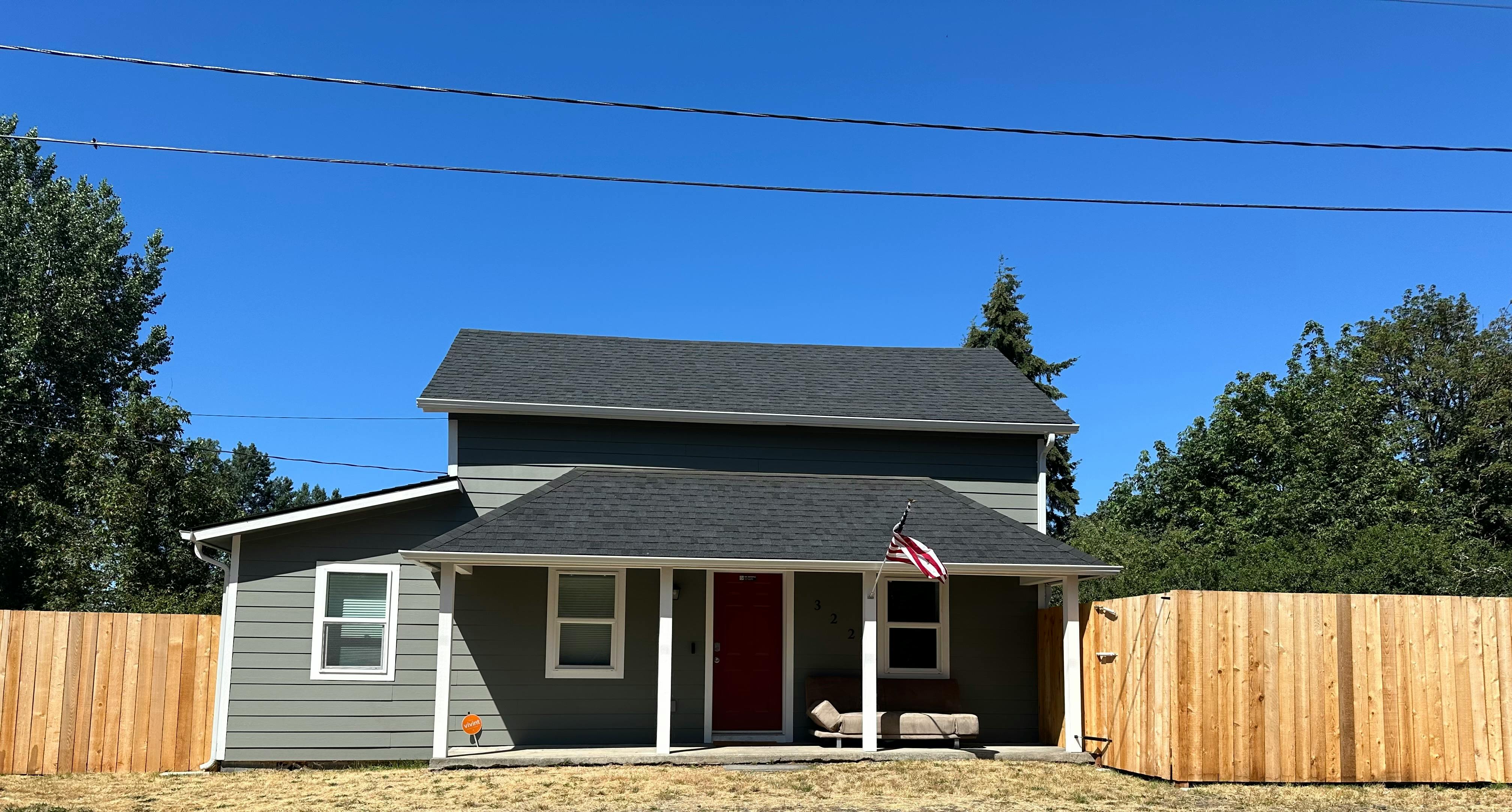House with a red door and a small porch
