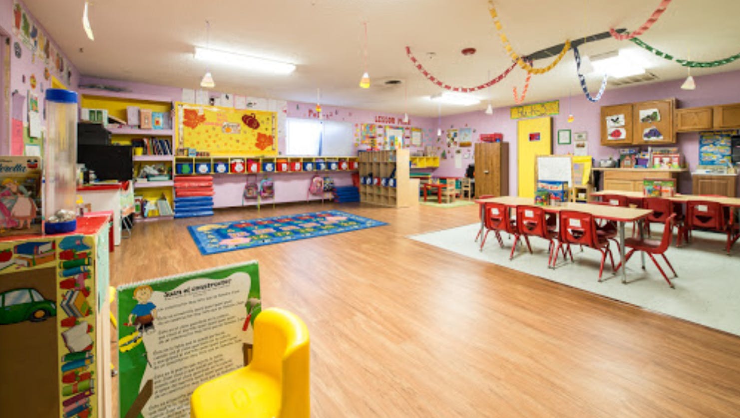 Empty classroom with small tables and chairs
