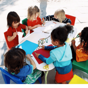 Children sitting around a table doing crafts