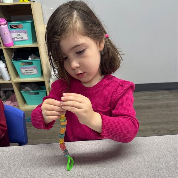 Child stringing beads