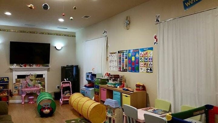 Playroom with toys, tunnels, and a television