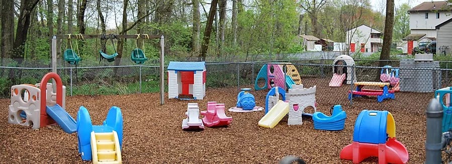 Outdoor playground with swings, slides, and various play structures