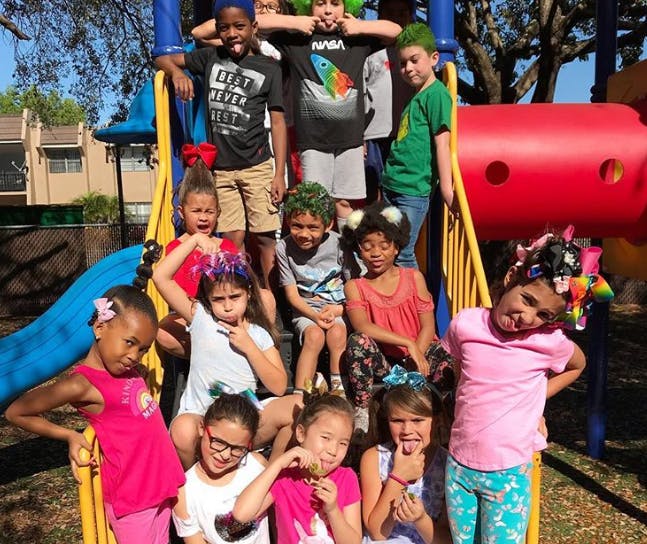 Group of children posing on playground equipment
