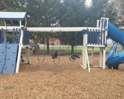 Playground with swings, slides, and climbing wall