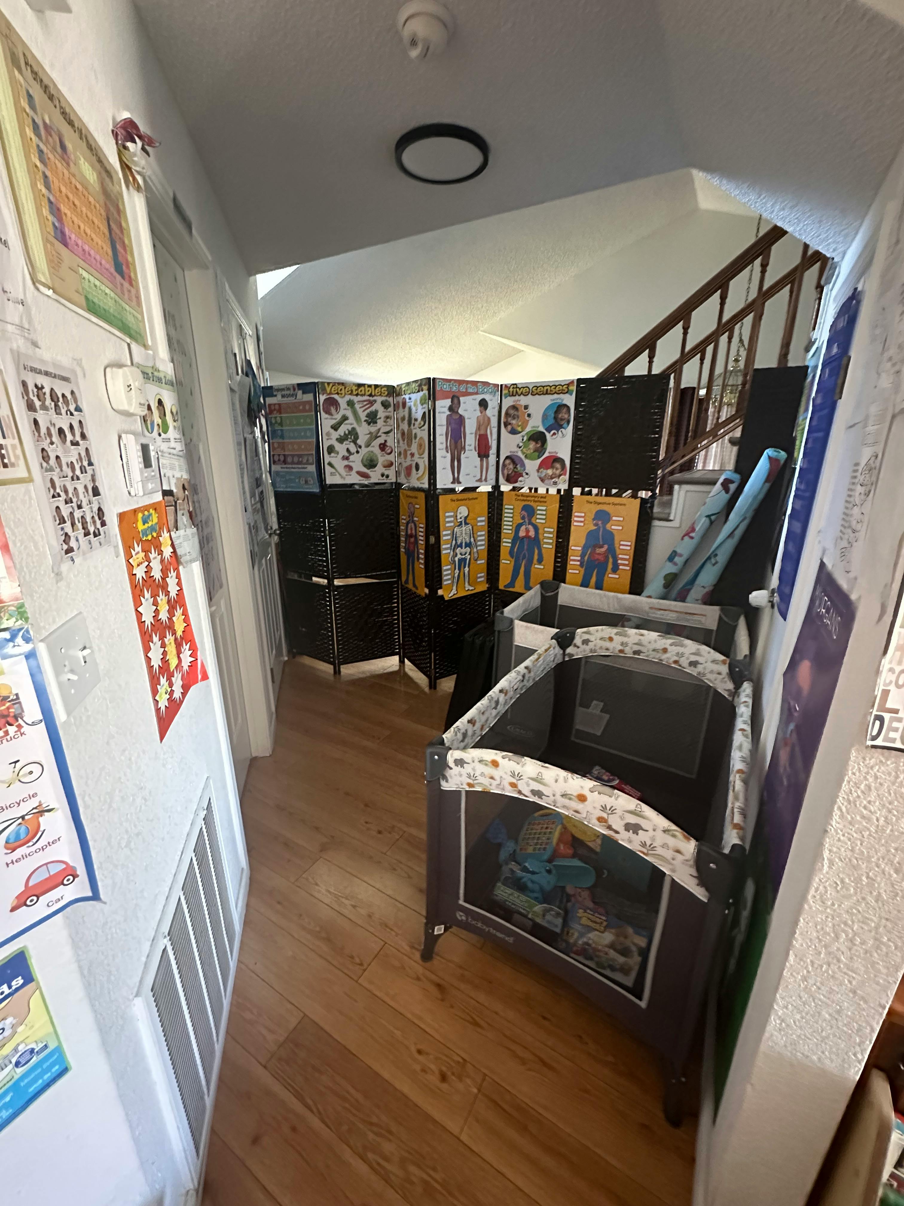 Hallway with a playpen and educational posters