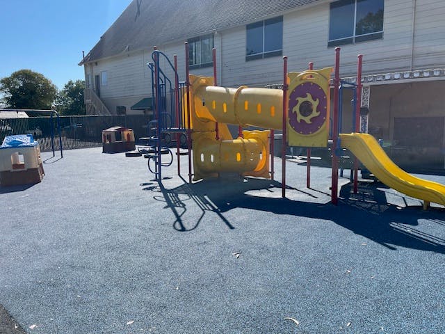 Playground with yellow slides and climbing structures