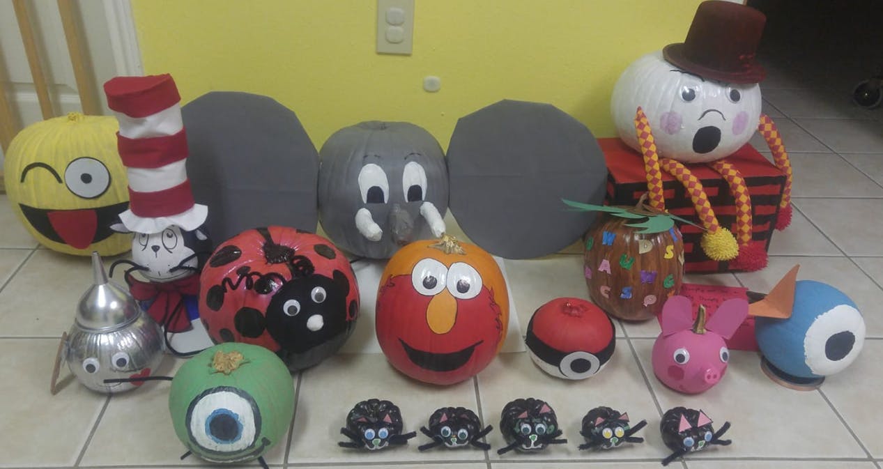 Collection of decorated pumpkins and gourds as characters