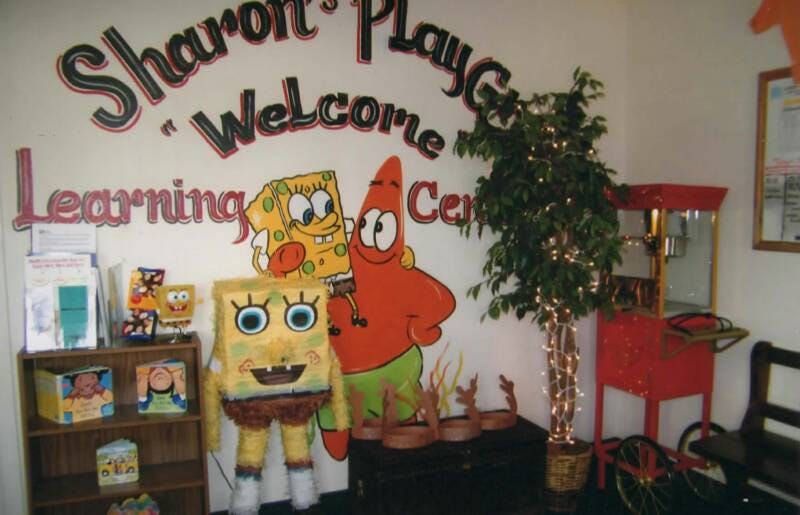Wall with "Sharon's Play Welcome Learning Center" and Spongebob characters