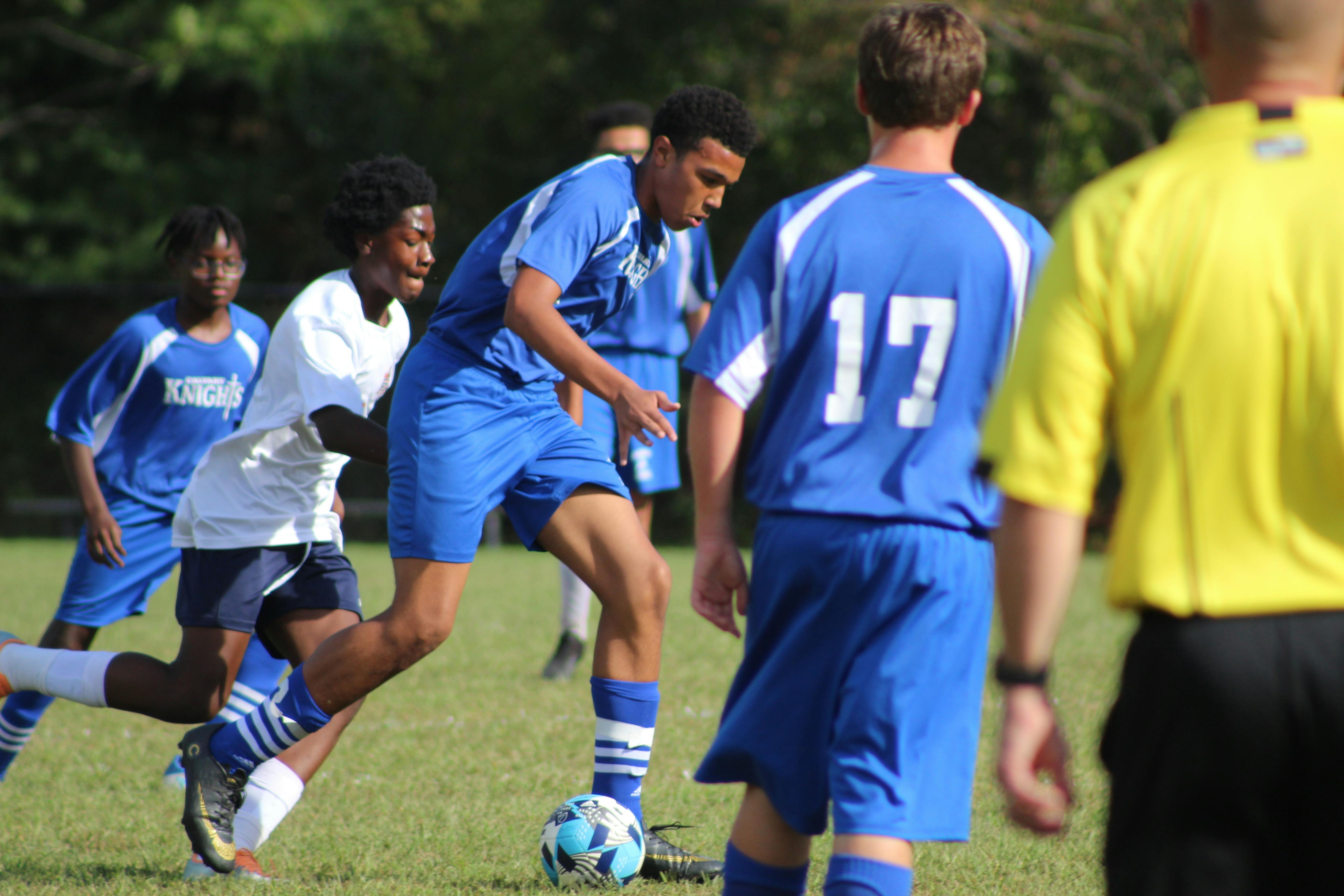 People playing soccer on a field