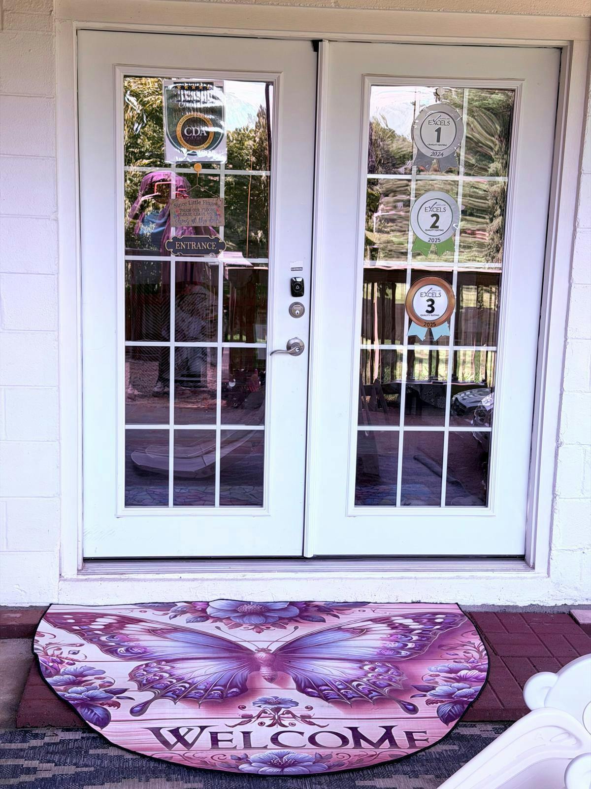 Double glass doors with entrance sign and quality rating stickers