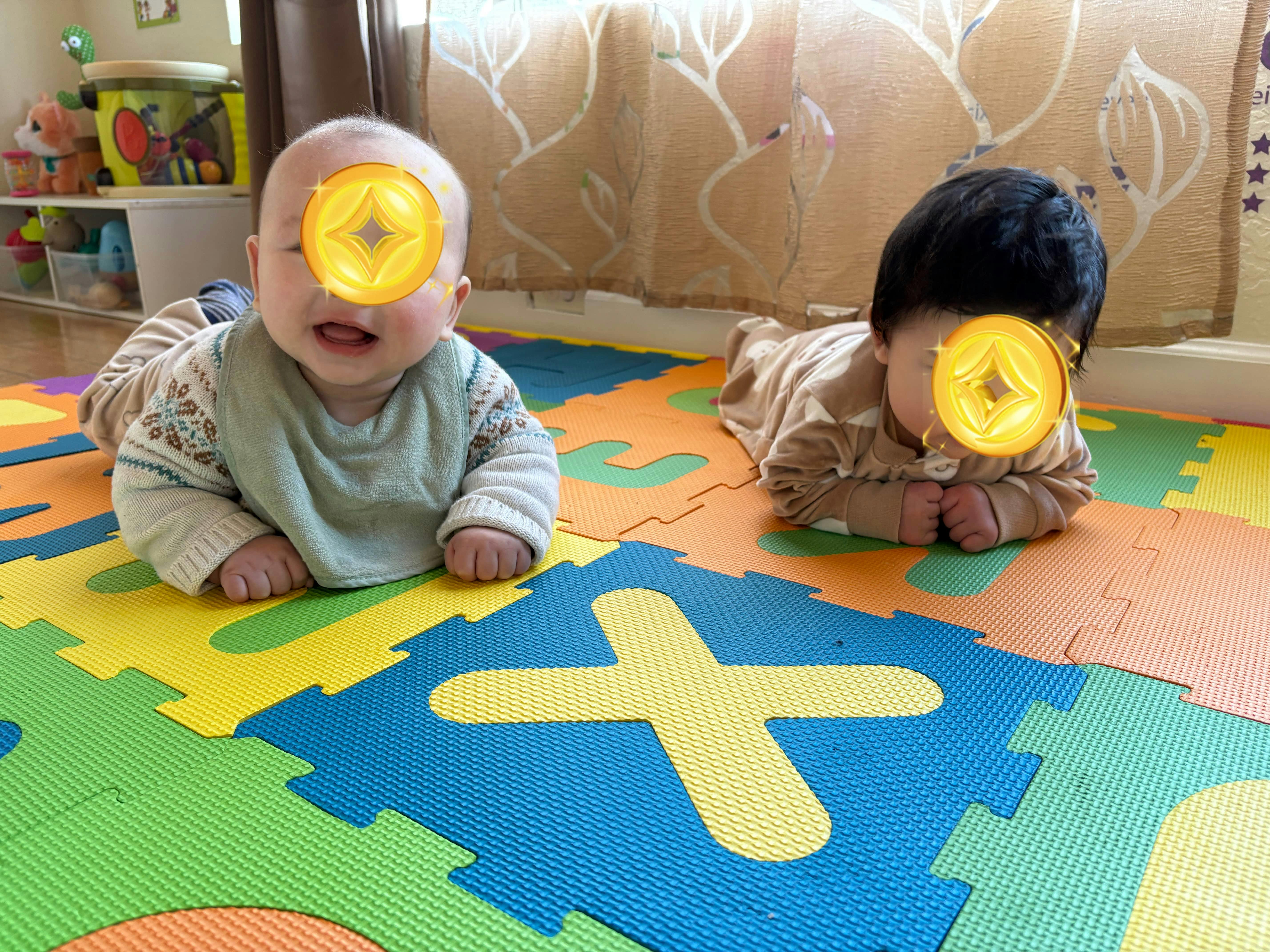 Two children on a colorful playmat