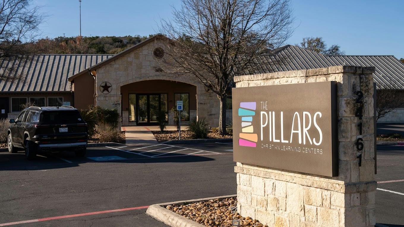 The Pillars Christian Learning Centers sign in front of a building
