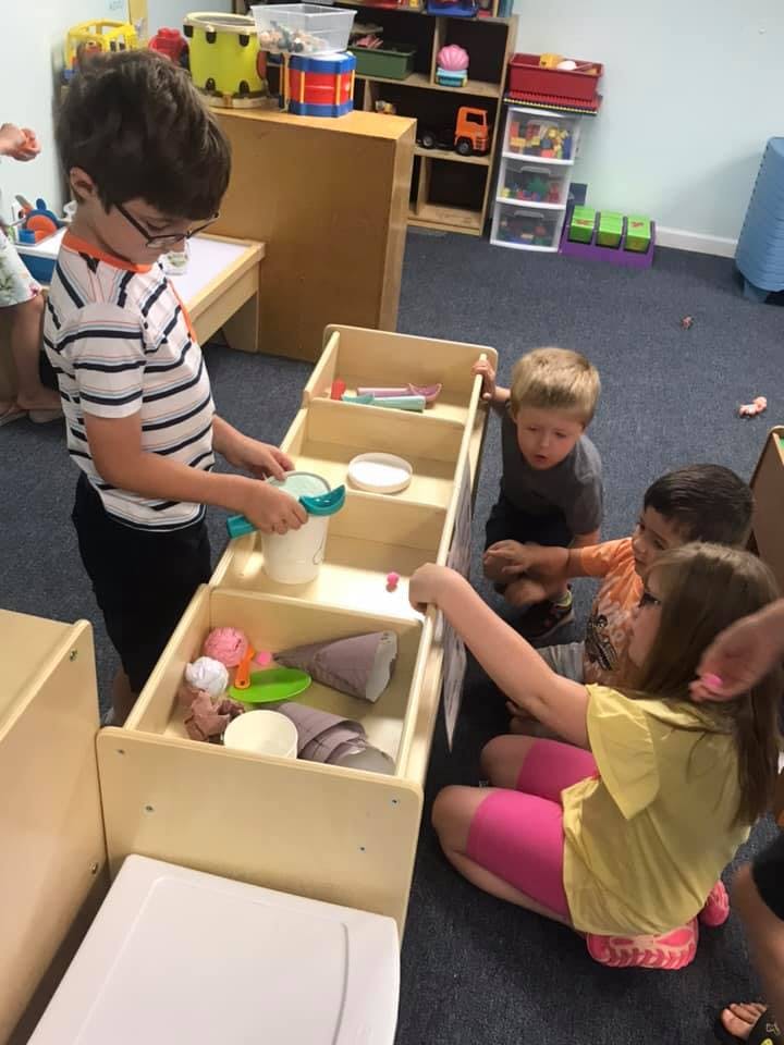 Children playing with toys in a classroom