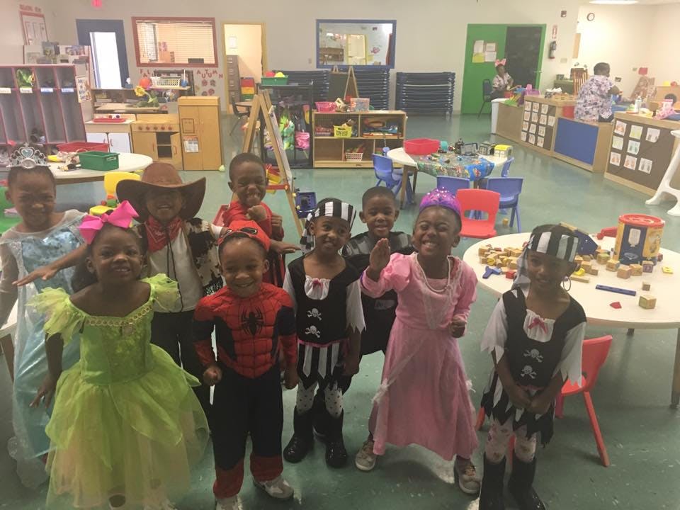 Group of children in costumes in a classroom
