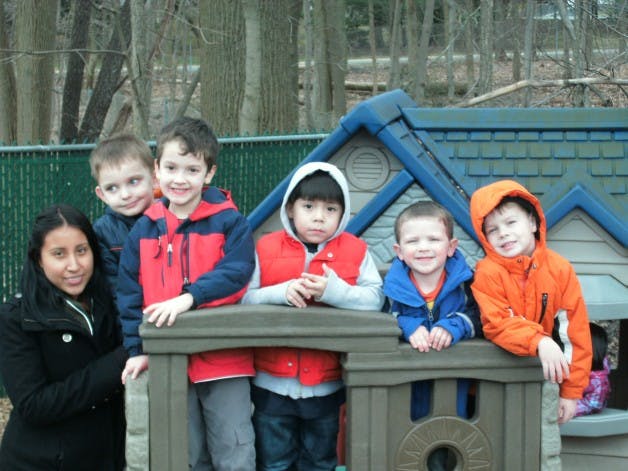 Adult and children on a playground structure