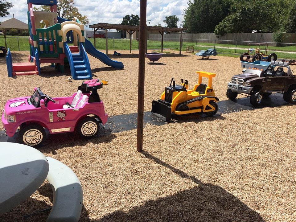 Toy vehicles on a playground with wood chips