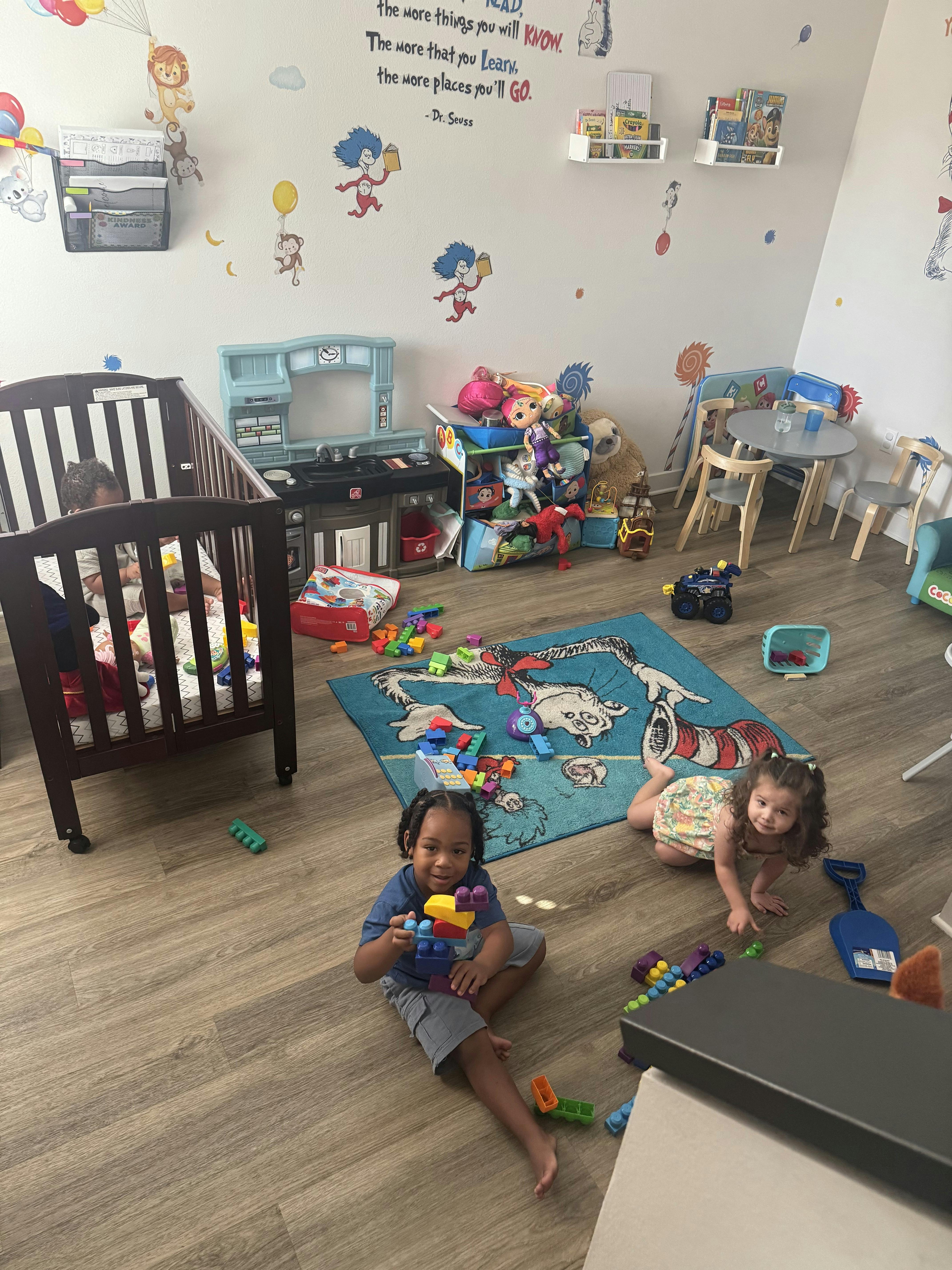 Children playing with blocks on a rug in a playroom