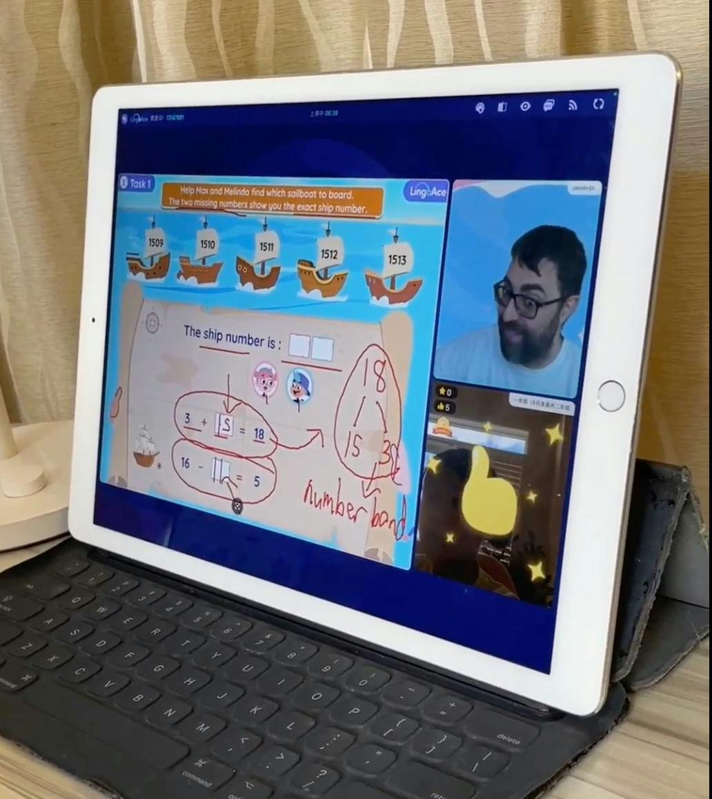 A tablet screen showing an online math lesson with a teacher and math problems