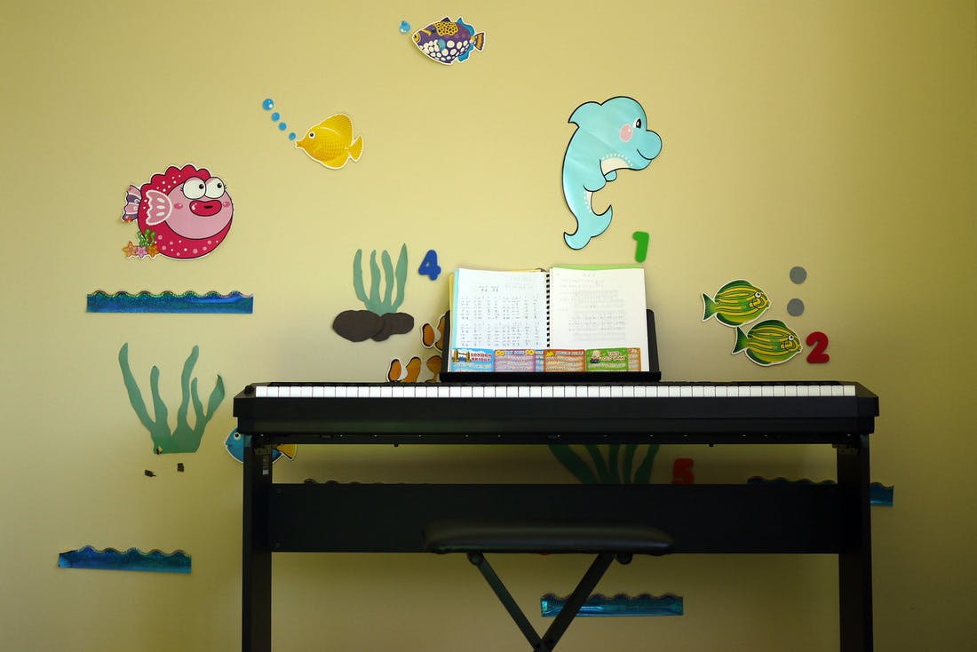 Digital piano with music stand and underwater-themed wall decals