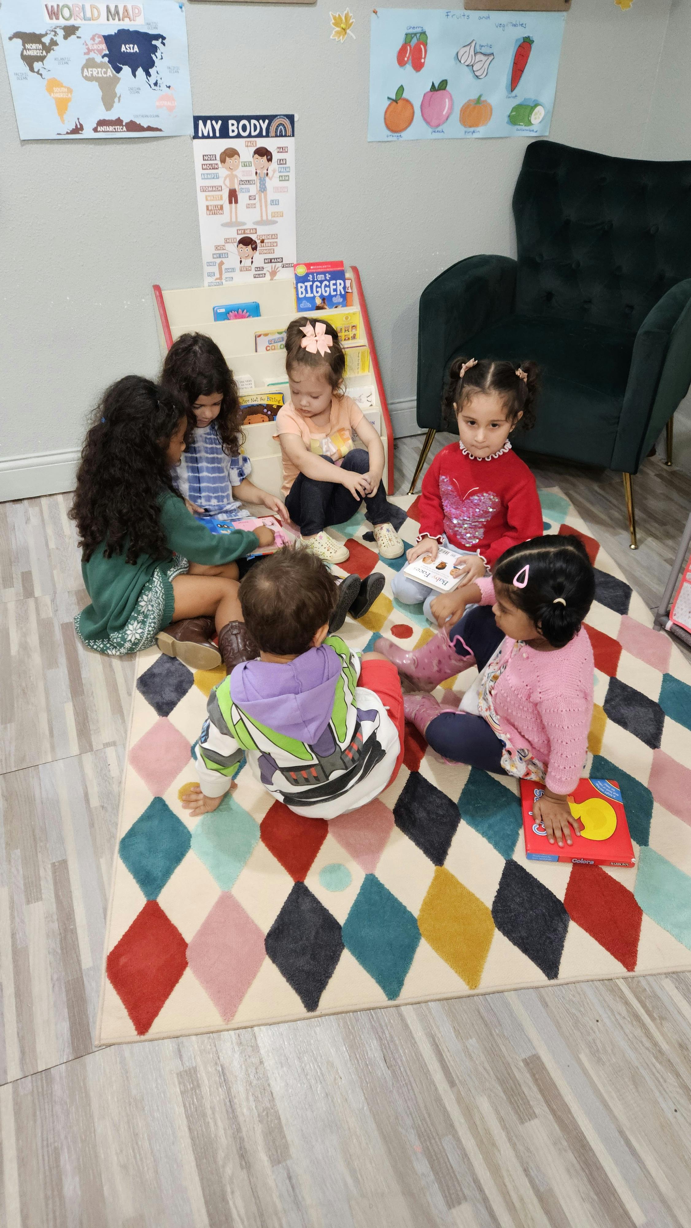 Children sitting on a rug in a classroom