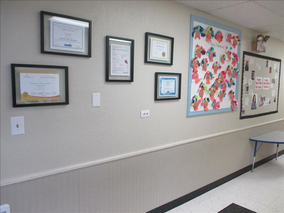 Certificates and child artwork on a wall