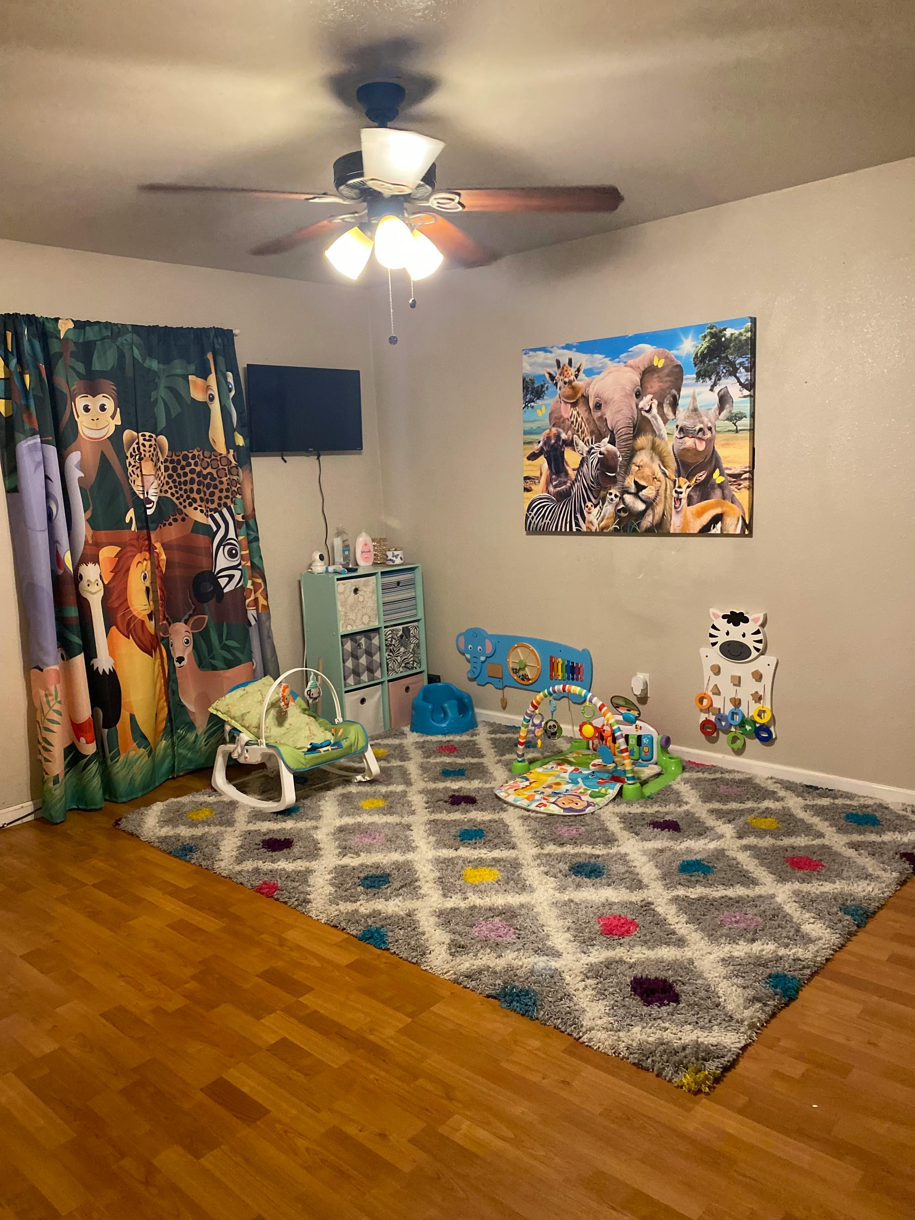 Nursery room with animal-themed decor and baby play items