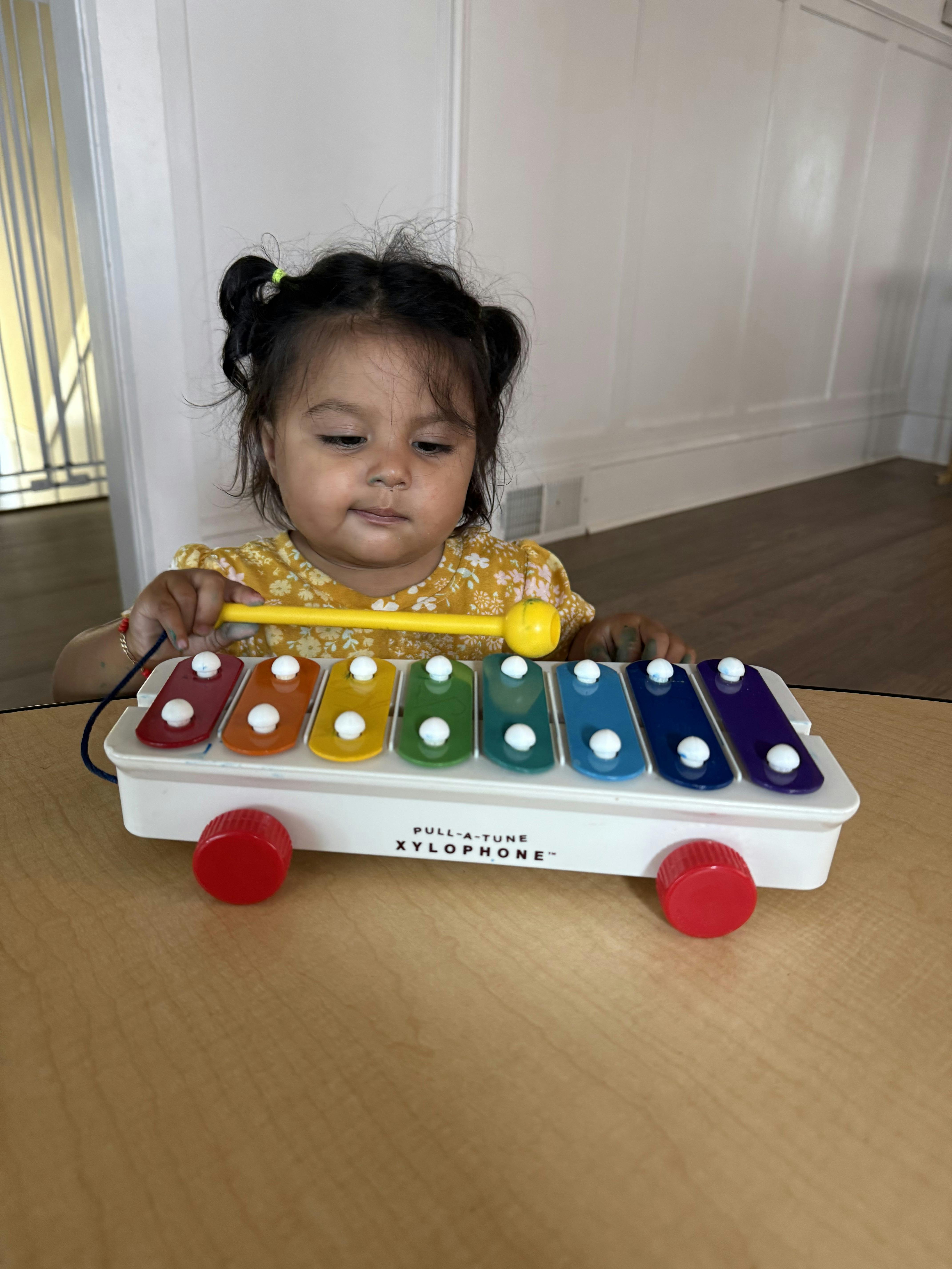 Child playing with a pull-a-tune xylophone