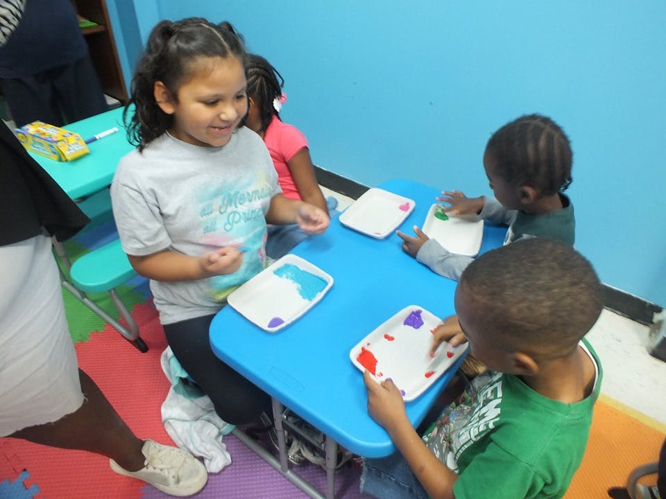 Children at a table with paper plates