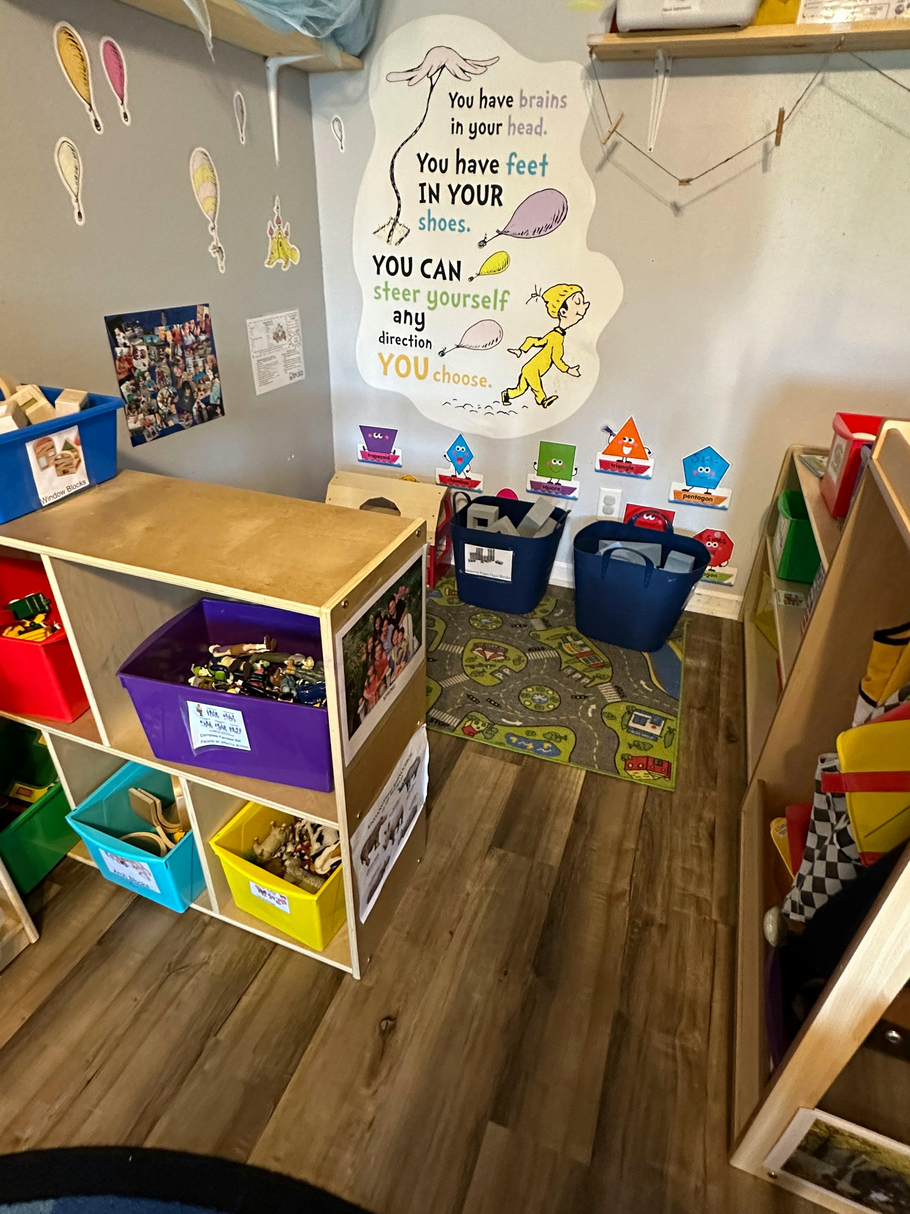Playroom with toy storage shelves and a Dr. Seuss wall decal