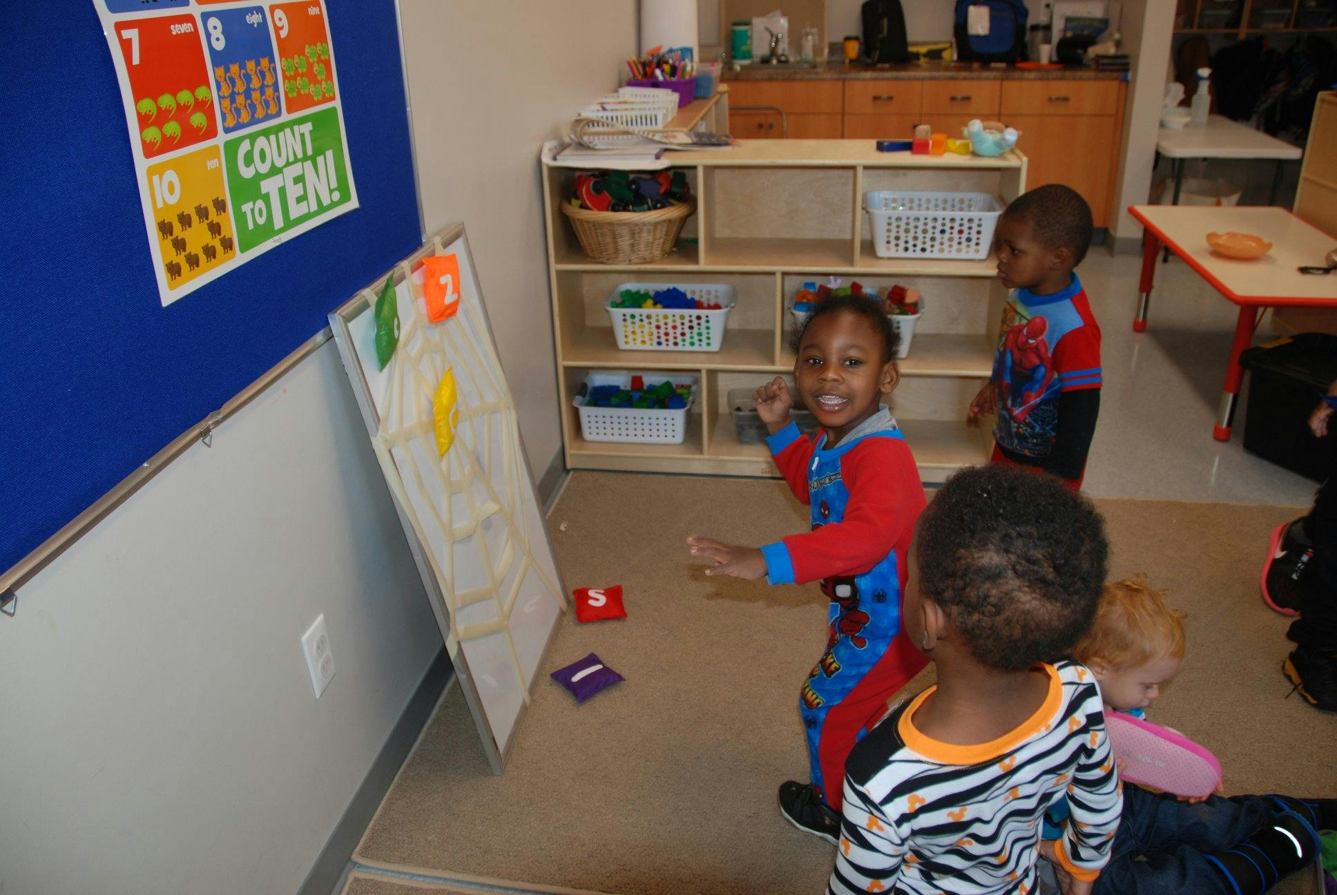 Three children playing in a room