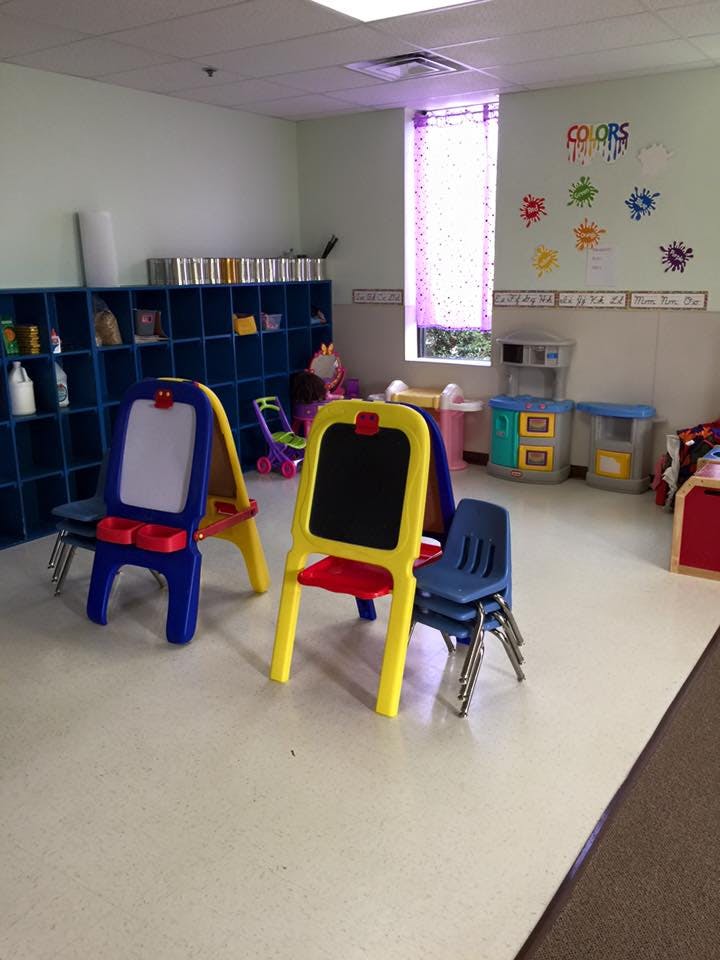 Classroom with easels, chairs, and cubbies