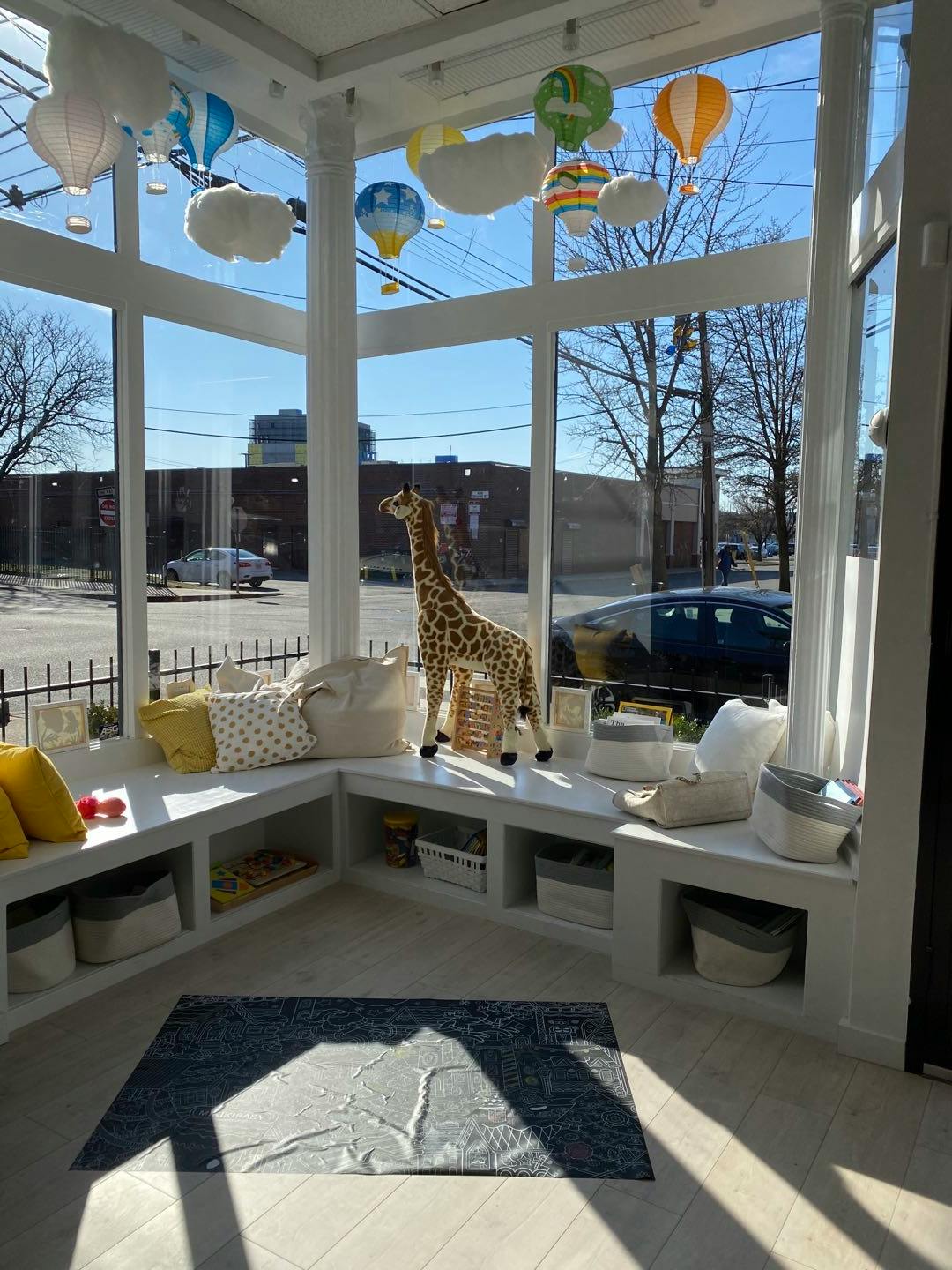 Giraffe toy on a window seat with hot air balloon decorations
