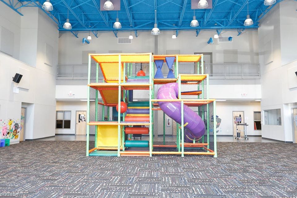 Indoor playground structure with slides and climbing areas