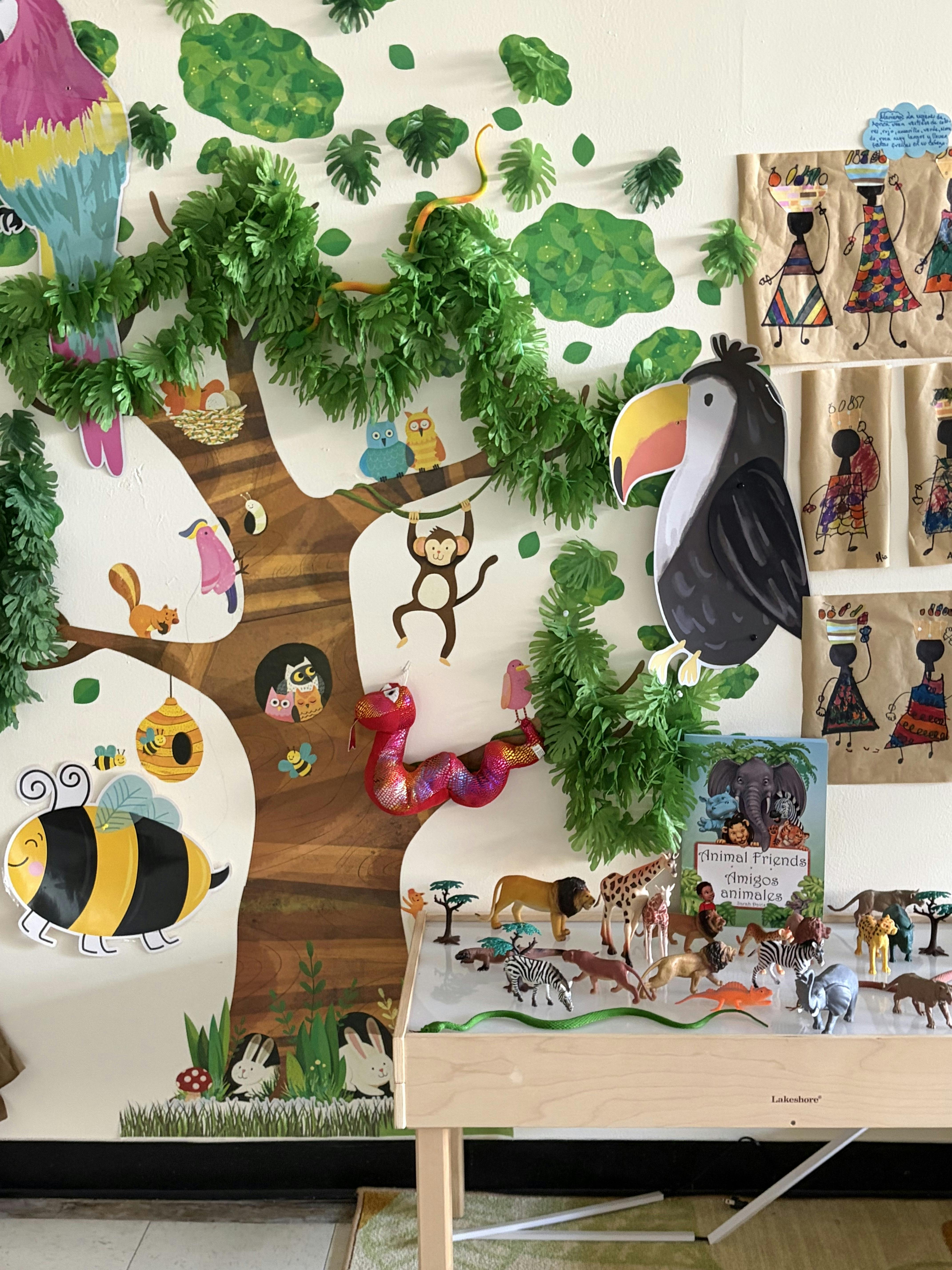 Jungle themed wall mural with animal cutouts and shelf displaying animal figures