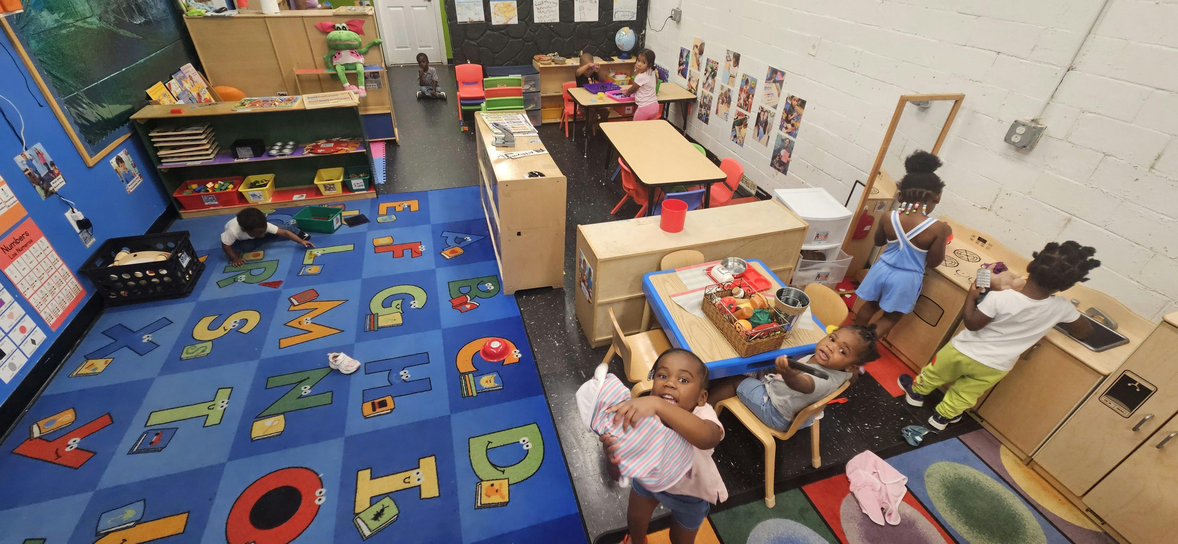 Multiple children playing in a classroom