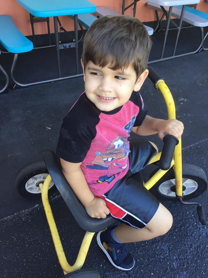 Child sitting on a tricycle