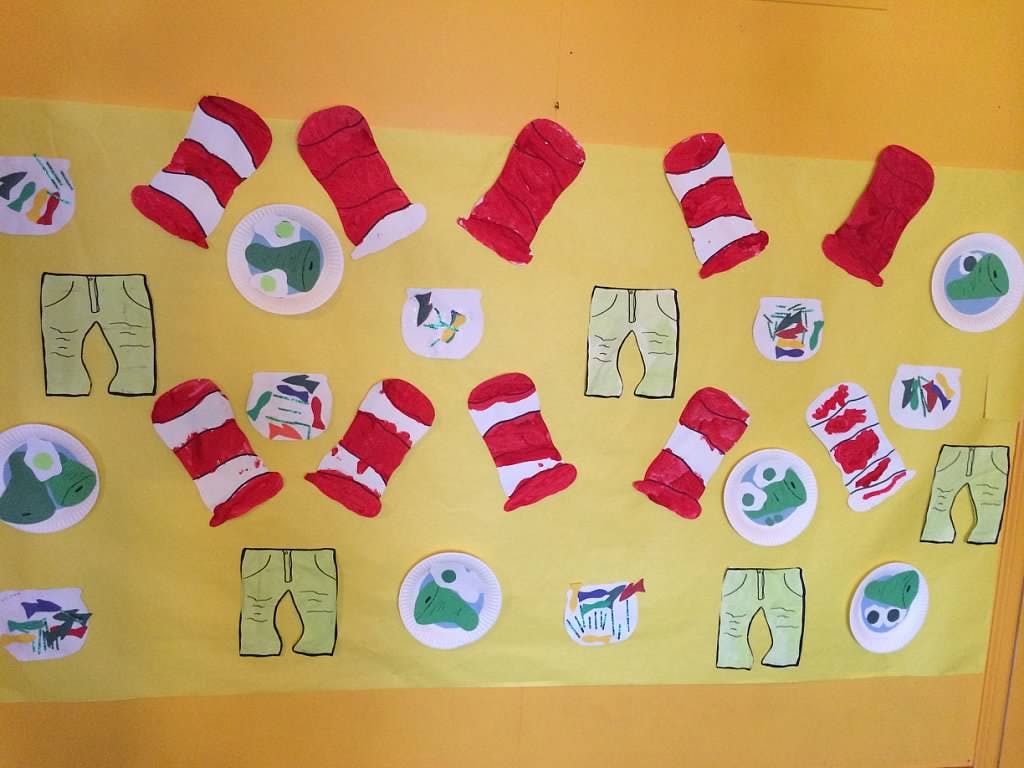 Red and white striped hats, green pants, and other cutouts on a yellow background
