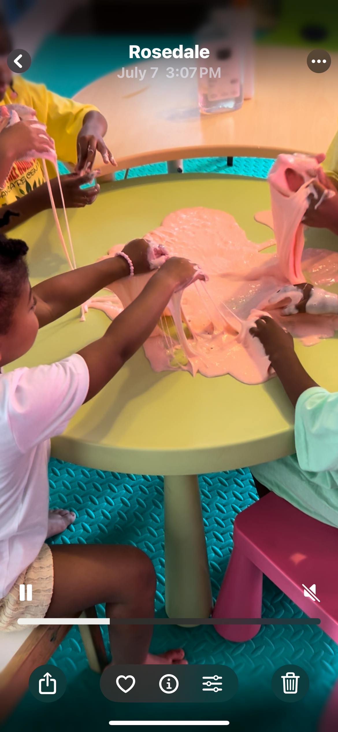 Children playing with pink slime on a table