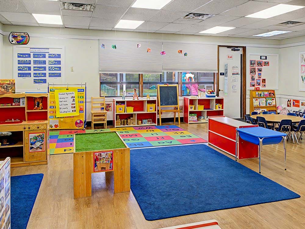 Colorful preschool classroom with various learning stations