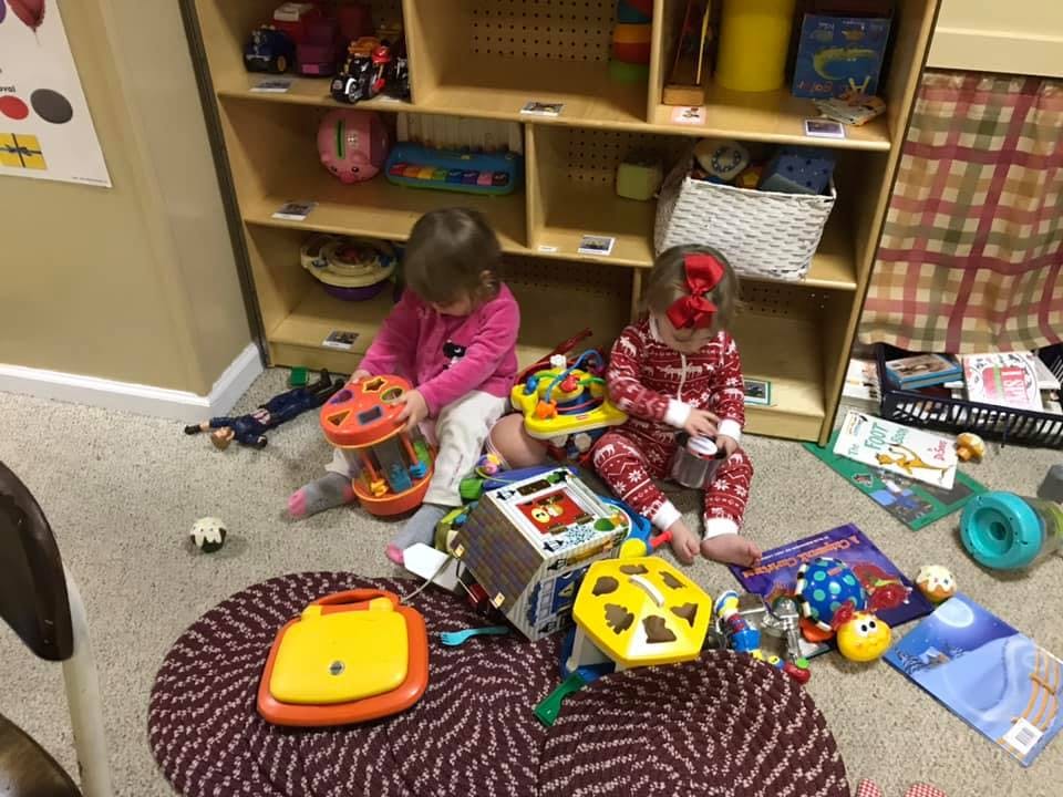 Two children playing with toys on the floor