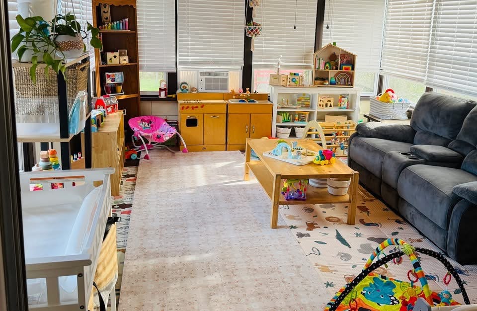 A well-organized sunroom converted into a playroom filled with various toys