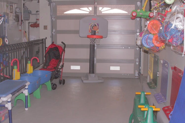 Garage with a child's basketball hoop and various toys