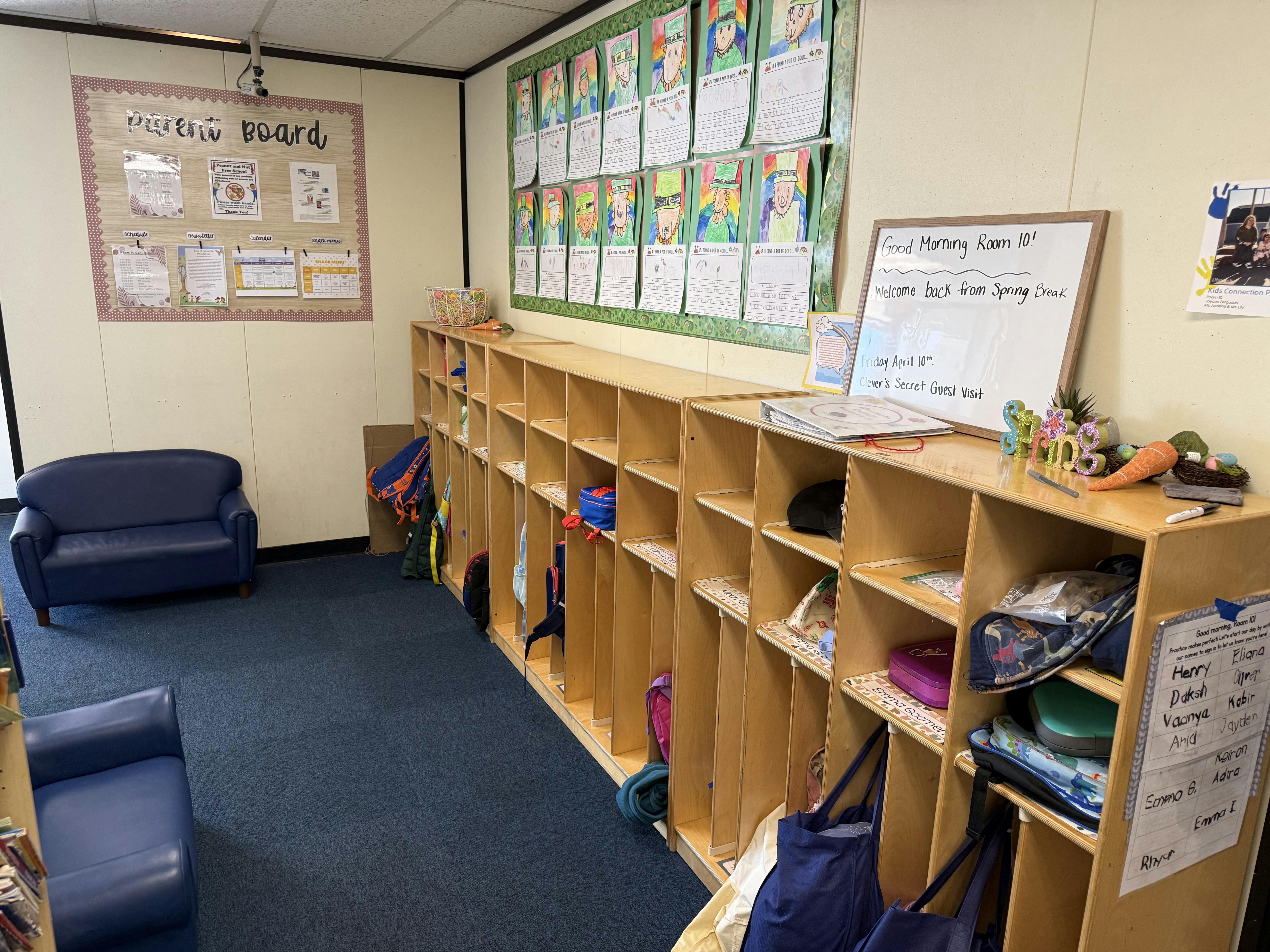 Classroom with cubbies for children's belongings and a 'Parent Board' on the wall