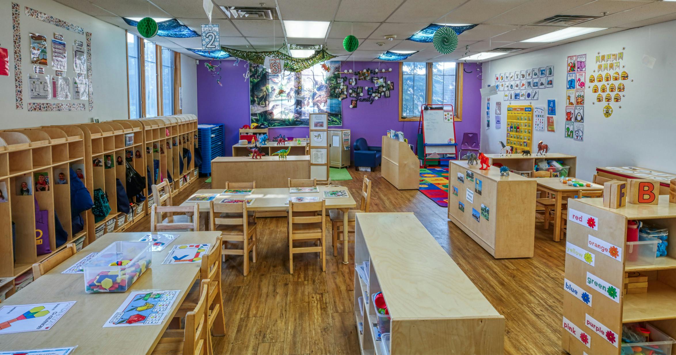 Colorful and organized classroom with small tables, chairs, and cubbies