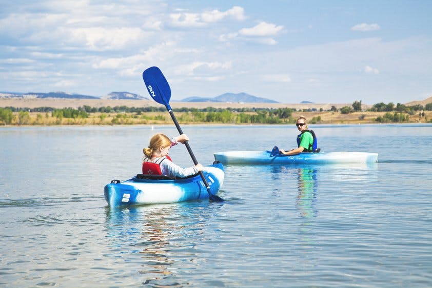 Two people kayaking on a lake