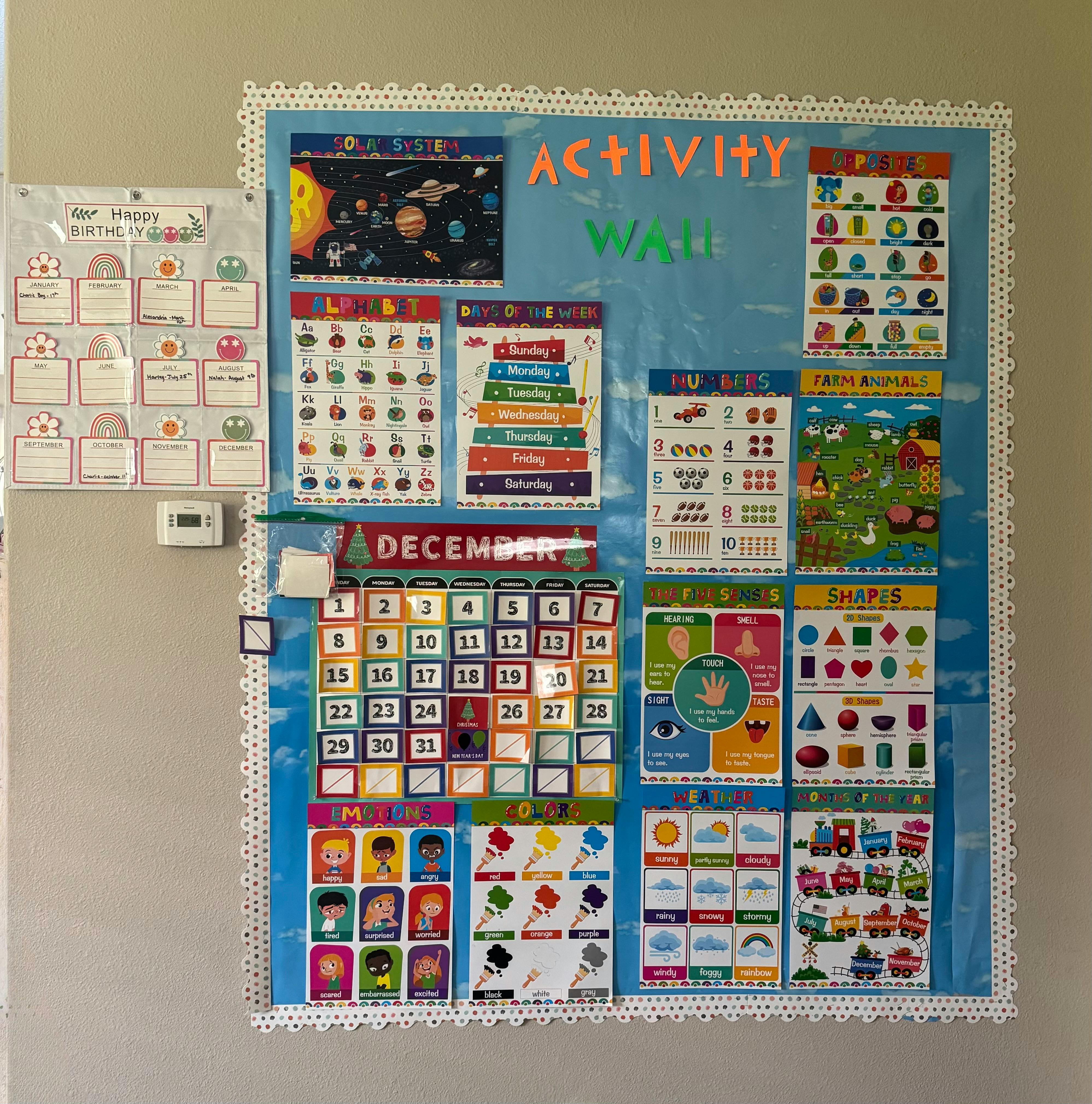 Activity board with a December calendar and various educational charts